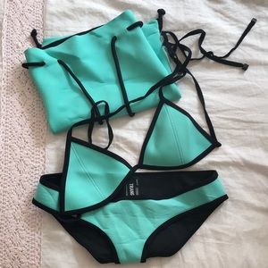Turquoise size medium Triangl swimsuit with bag.